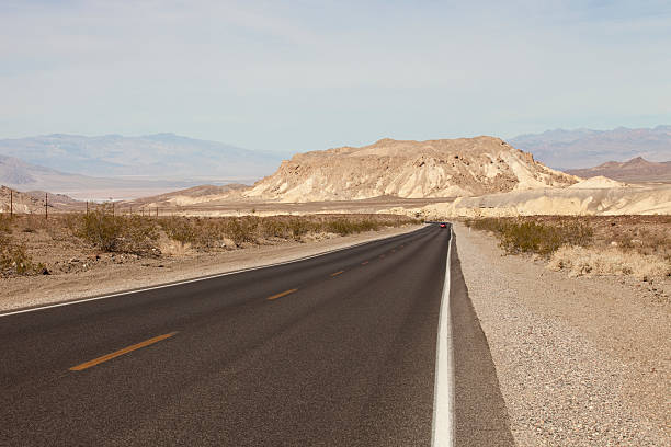 istock Desert Road heading to mountain range in Death Valley 520912091
