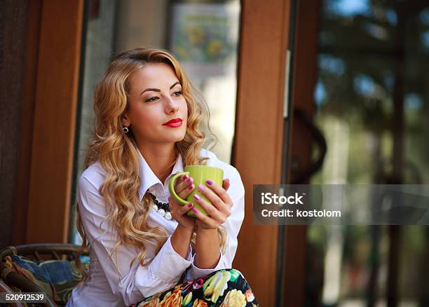 Pensive Woman Sitting With Coffee Cup Outdoors Stock Photo - Download Image Now - Adult, Adults Only, Beautiful People
