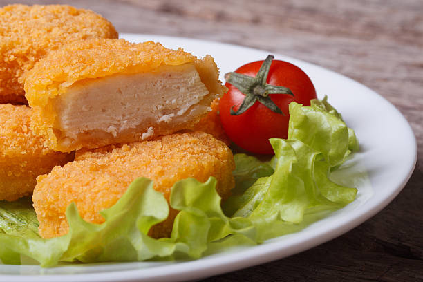 istock Sliced ​​chicken nuggets, salad and cherry tomatoes 520913255