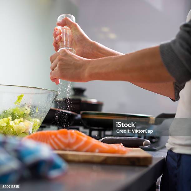 Young Woman Seasoning A Salmon Filet Stock Photo - Download Image Now - Fish, Salmon - Seafood, Cooking