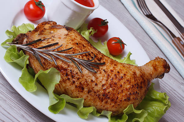 istock Roasted chicken leg with rosemary, lettuce and ketchup 520914525