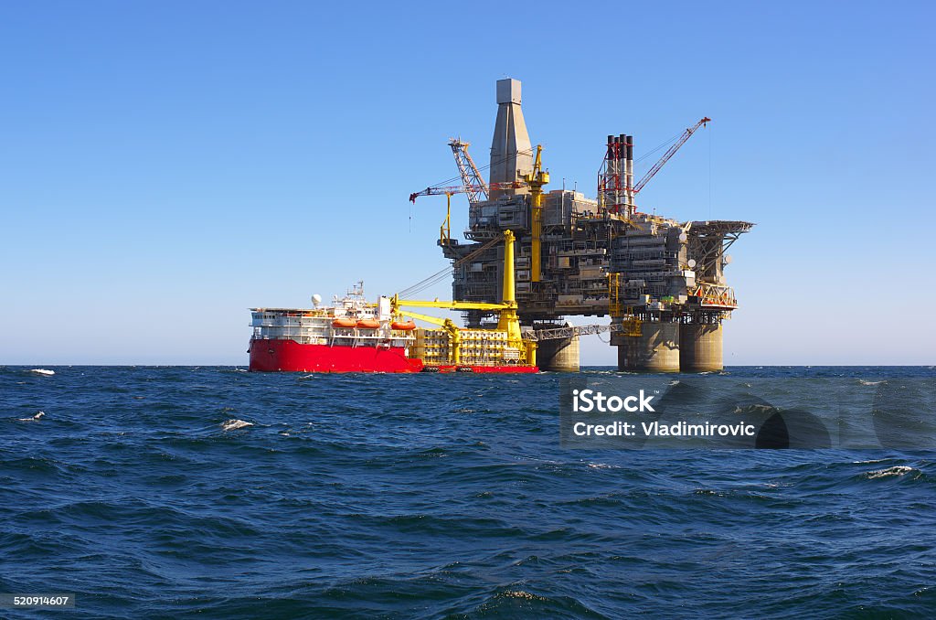 Oil rig Oil rig and support vessel on offshore area. Blue sky background Above Stock Photo