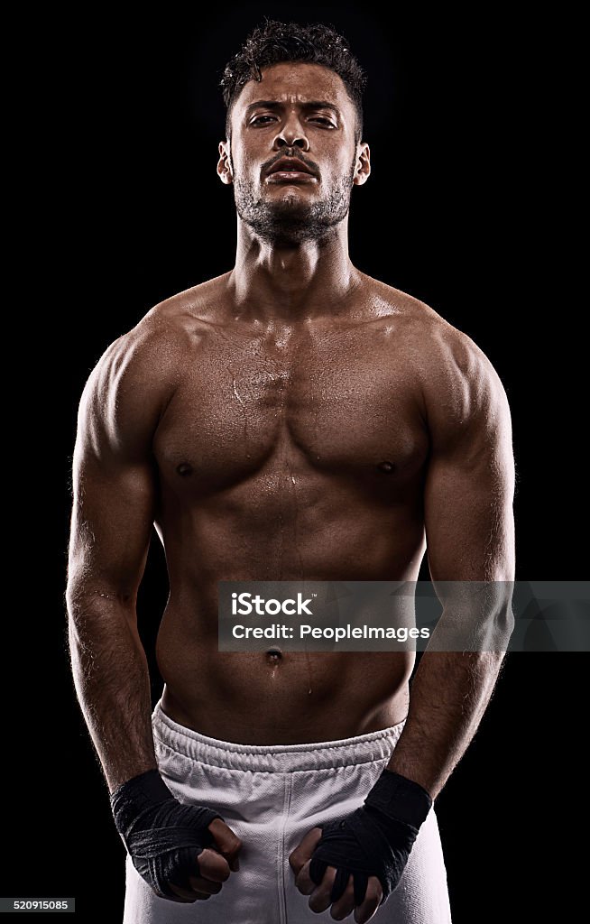 Learning is a gift even when pain is the teacher Studio shot of a young boxer isolated on black Adult Stock Photo