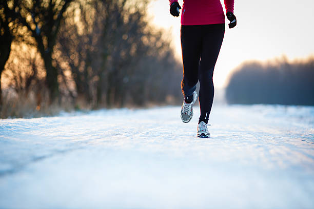 istock Young woman running outdoors on a cold winter day 520915619