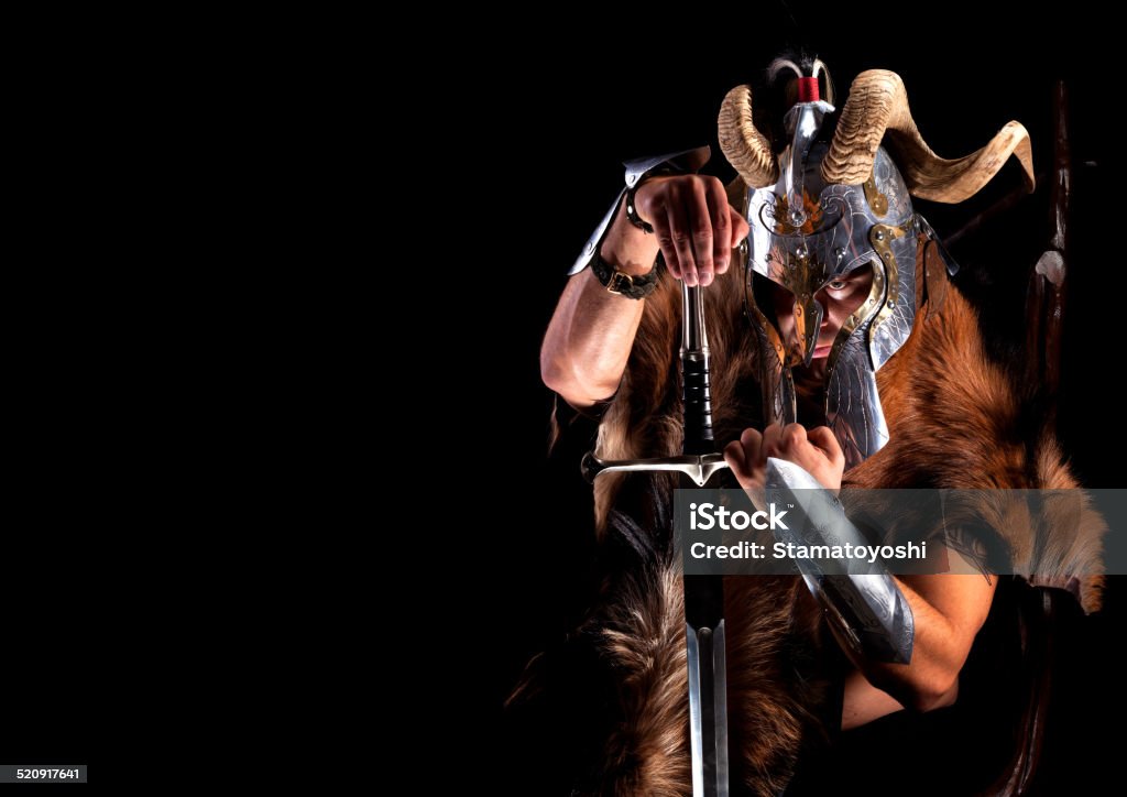 Viking 2 Muscular man in viking costume with horned helmet , shield and sword Viking Stock Photo