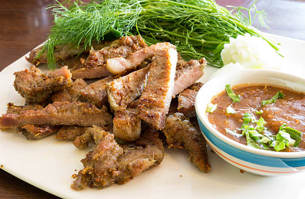 istock Grilled pork whit spicy sauce in white plate 520933760