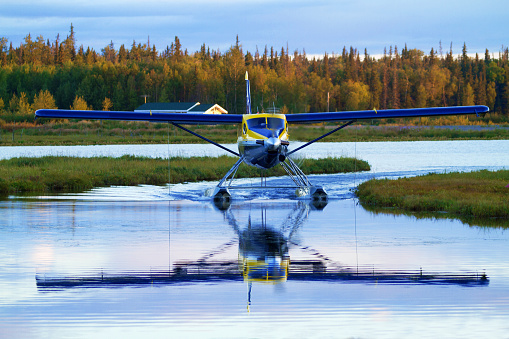 Float plane landing on water in Alaska