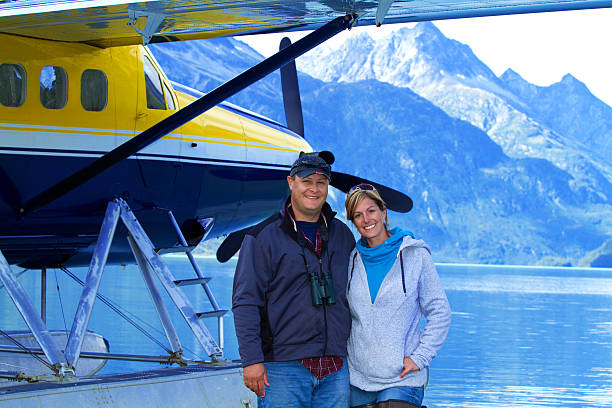 Alaskan Fly out Couple on a float plane in Alaska bush plane stock pictures, royalty-free photos & images