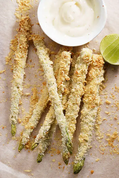 Crunchy baked asparagus fries with mayonnaise dip, healthy vegetable snack