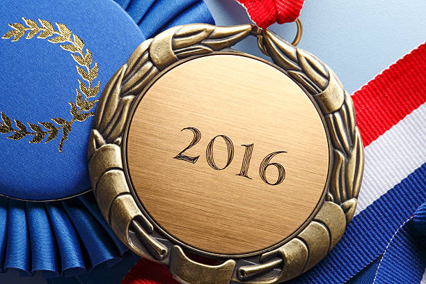 istock Gold Medal Engraved With 2016 Resting On Blue Ribbon 520935584
