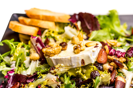 gourmet salad with augula, goat cheese grilled,cherry tomato,hazelnuts,walnuts, almonds and Raising