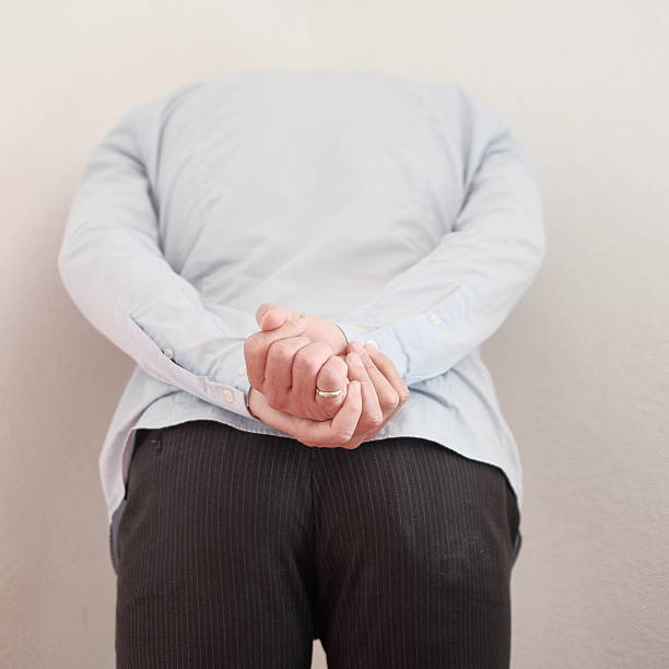 istock Crestfallen man, punished, hides himself in the corner 520937496