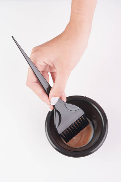 istock hair dye mixing bowl and brush 520939178
