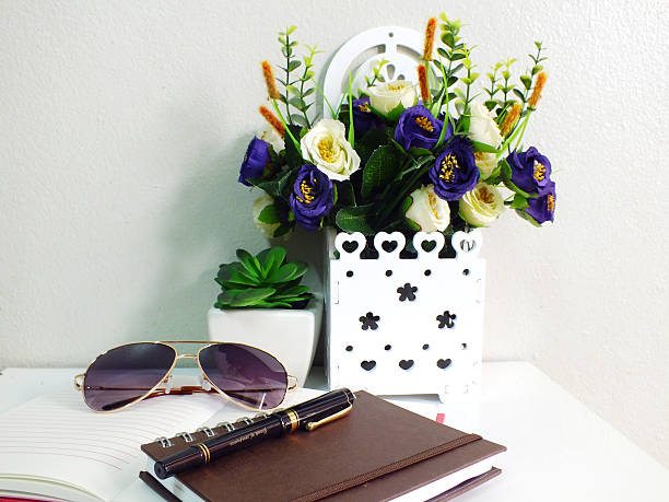 istock stack of notebook with artificial of plant and sunglasses 520939988