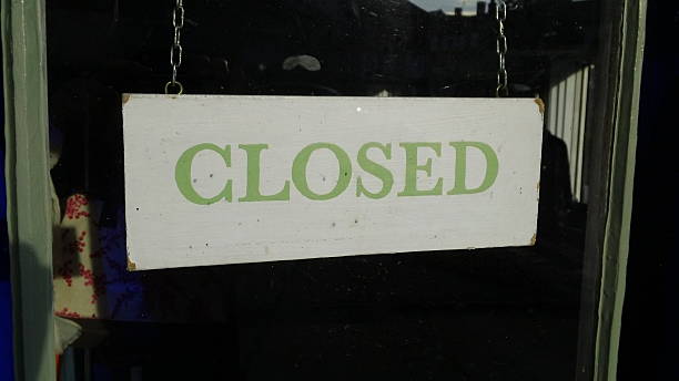 istock 'Closed' sign hanging in a shop window 520940966