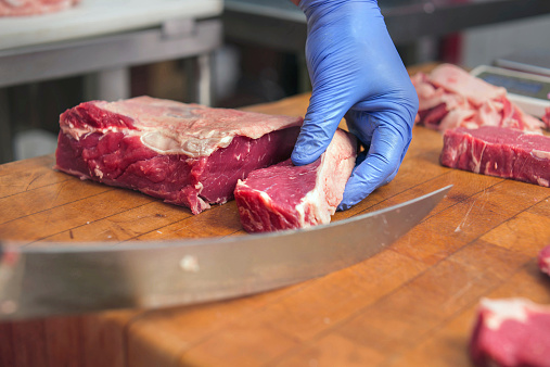 Butcher cutting steaks