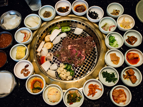 top view of Korean BBQ with full side dishes