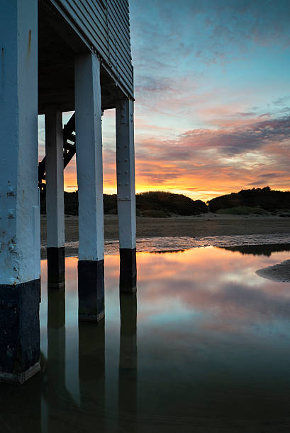 istock Beautiful landscape sunrise stilt lighthouse on beach 520941421