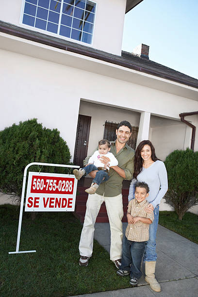 istock Happy Homeowners with For Sale Sign 520942151