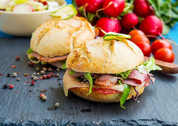 istock Sandwiches with bacon, cheese, salad and rustic bread 520942158