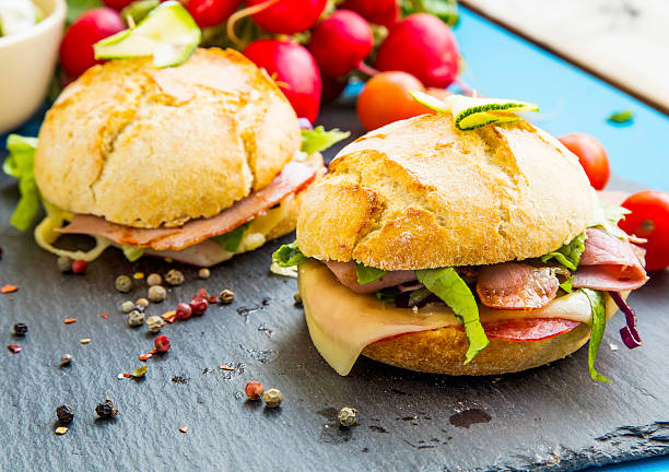 istock Sandwiches with bacon, cheese, salad and rustic bread 520942184