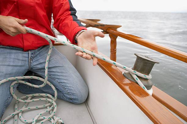 istock Man with rope on a sailboat 520942260