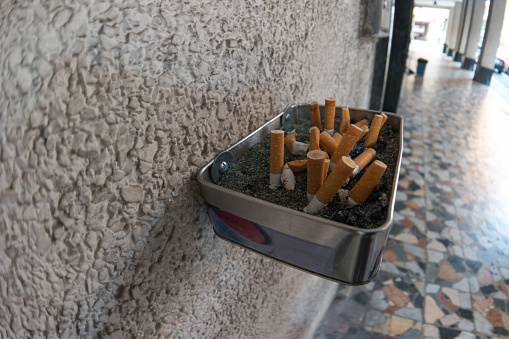 ashtrays of cigarette butts outdoors