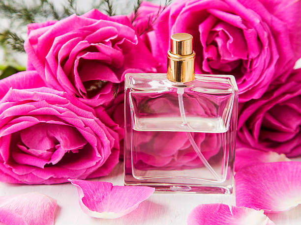 istock Floral perfume with pink roses in transparent bottle 520943450