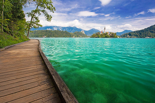 Wooden pathway on the coast of lake Bled in Slovenia stock photo