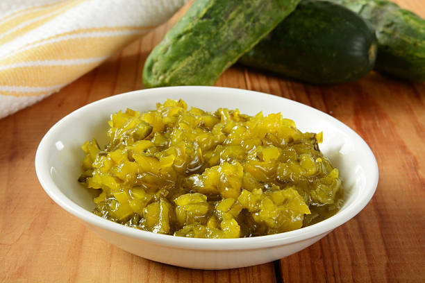 Relish and cucumbers A bowl of relish with Kirby pickling cucumbers in the background Relish stock pictures, royalty-free photos & images