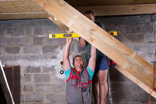 istock Two Men Building Stairs in Unfinished Basement 520945110