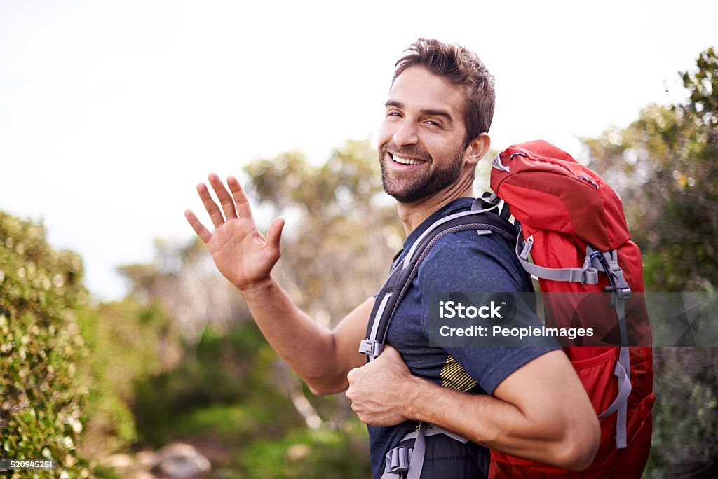 Life is better when you're hiking Shot of a man enjoying a hike on a sunny day Looking At Camera Stock Photo