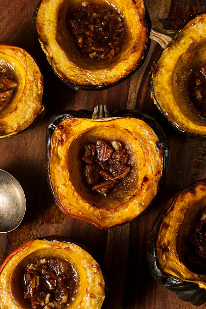 Homemade Roasted Acorn Squash Homemade Roasted Acorn Squash with Brown Sugar and Pecans acorn squash stock pictures, royalty-free photos & images