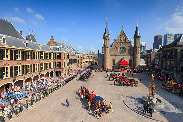 royal carriage arriving on Binnenhof during Prinsjesdag The Hague, Netherlands - September 16, 2014: royal carriage arriving on Binnenhof during Prinsjesdag, the day on which King Willem-Alexander addresses a joint session of the Dutch Senate and House of Representatives in the Knights' Hall. The Speech from the Throne sets out the main features of government policy for the coming parliamentary session. binnenhof photos stock pictures, royalty-free photos & images
