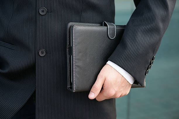 istock Businessman holding a day planner 520946844