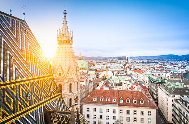Vienna skyline with St. Stephen's Cathedral roof, Austria Aerial view over the rooftops of Vienna from the north tower of St. Stephen's Cathedral including the cathedral's famous ornately patterned, richly colored roof created by 230,000 glazed tiles, Austria st. stephens cathedral vienna photos stock pictures, royalty-free photos & images