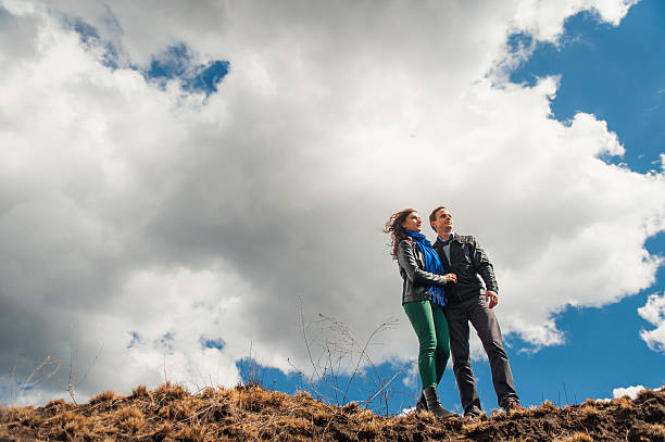Happy couple smiling outdoors on hiking trip in the mountains