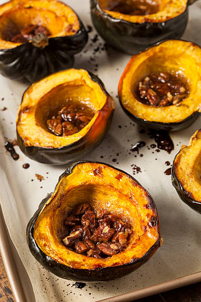 Homemade Roasted Acorn Squash Homemade Roasted Acorn Squash with Brown Sugar and Pecans acorn squash stock pictures, royalty-free photos & images