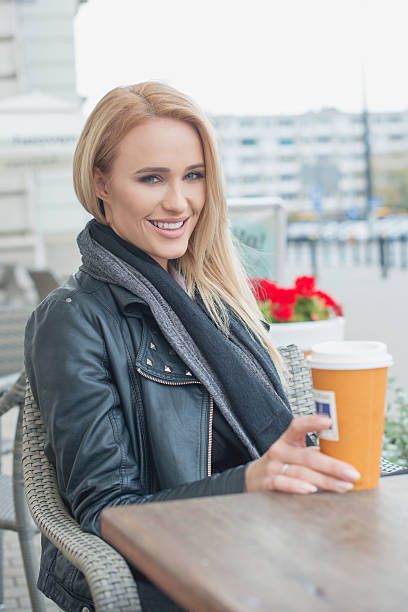 istock Attractive woman sitting drinking coffee 520947597