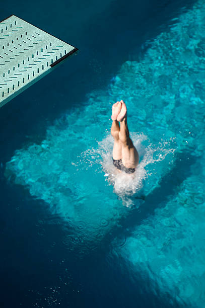 istock Swimmer diving into swimming pool 520947869