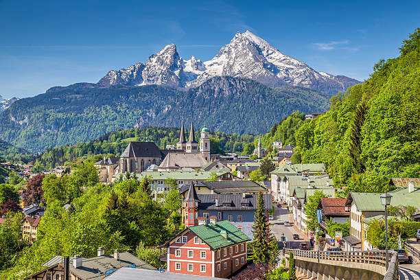 Historic town of Berchtesgaden with Watzmann mountain, Bavaria, Germany Historic town of Berchtesgaden with famous Watzmann mountain in the background on a sunny day with blue sky and clouds in springtime, Nationalpark Berchtesgadener Land, Upper Bavaria, Germany. bavarian alps photos stock pictures, royalty-free photos & images