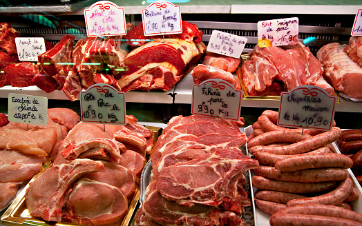 Different cuts of fresh beef, pork, lamb and other meats for sale at famous Les Halles farmer's market in Dijon, France. Concepts could include food, health, culture, travel, and others