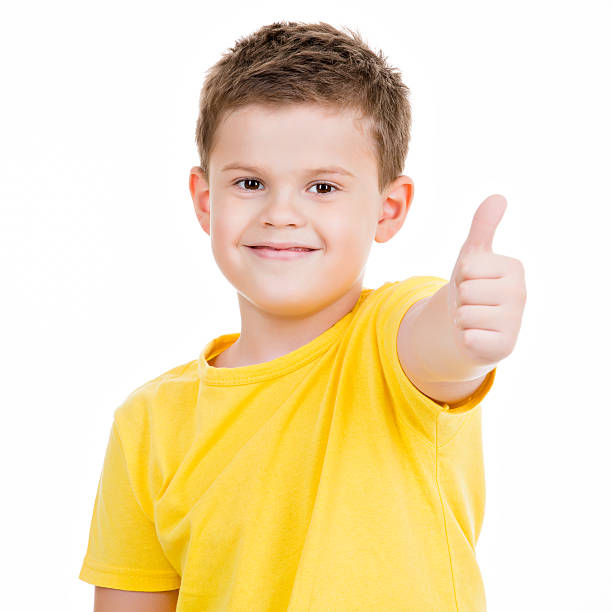 istock happy boy showing thumbs up gesture 520958635