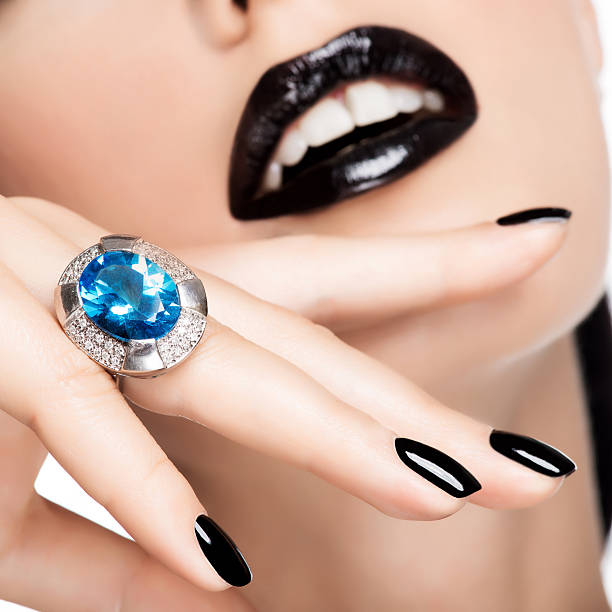 istock Woman's lips and nails painted bright color blac 520959089