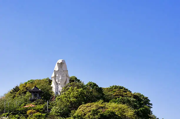 Ofuna Kannon. Against the background of the blue sky of spring.