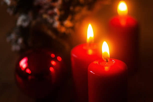 istock burning candles and christmas decoration 520960433