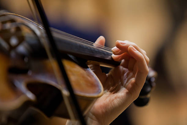 istock Girl's hand on the strings of a violin 520960525
