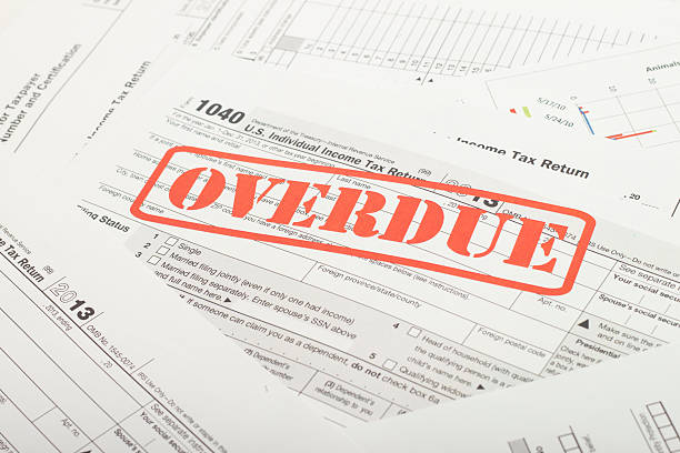 Income Taxes Close up U.S. taxes papers past due stock pictures, royalty-free photos & images