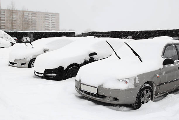 istock Cars under snow on parking place 520962249