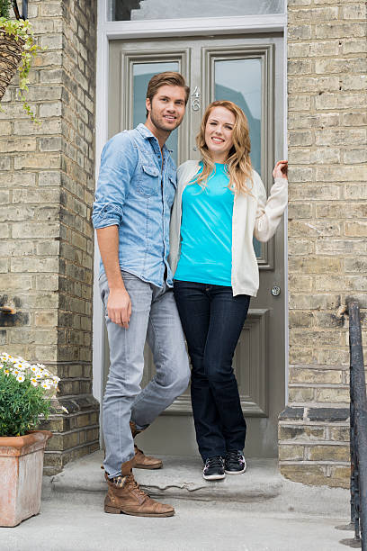 istock Happy Couple Standing At House Front Door 520962335